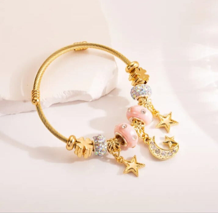 Pulsera elegante y dulce aleación de lunas y estrellas en acero de titanio en dorado y rosa